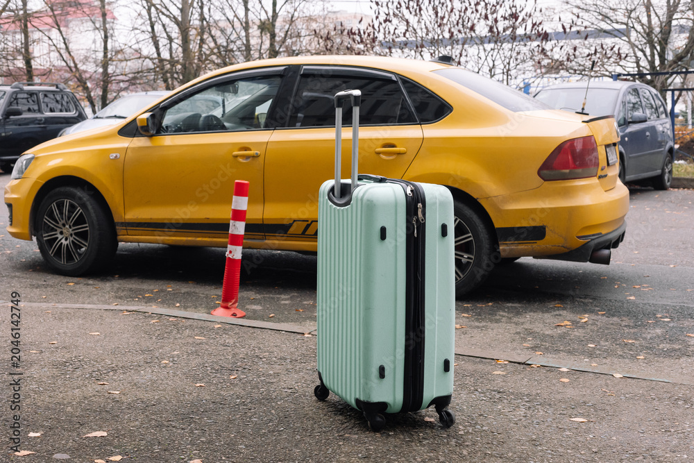 Naklejka premium suitcase, backpack, travel bag next to the car in the parking lot