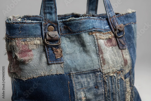 rugged denim tote bag with stitched patches and raw edges
