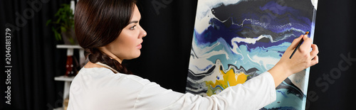Canvas Print In a cozy corner, a creative young woman expresses her artistry with vibrant col