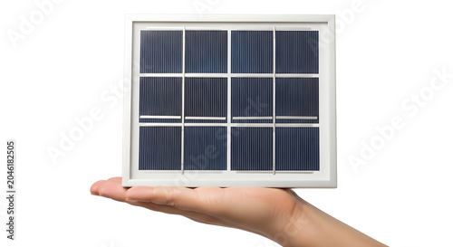 Hand holding small solar panel with multiple black cells