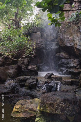 small human made waterfall inside garden