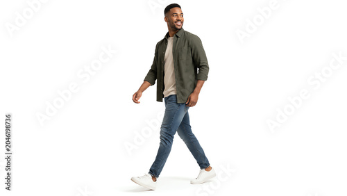 A man walks confidently in casual attire, embodying a sense of style and ease in an urban setting.