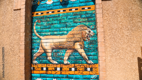 Vibrant lion mural adorns ancient walls in Babylon Iraq reflecting cultural heritage