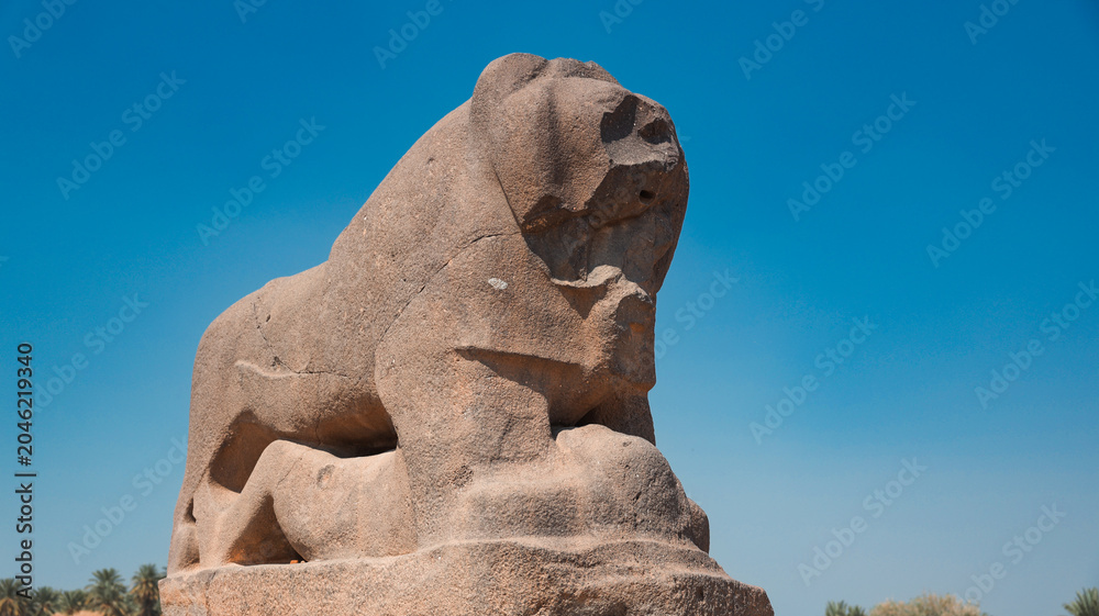 Fototapeta premium Ancient lion sculpture in Babylon, Iraq showcasing historical craftsmanship