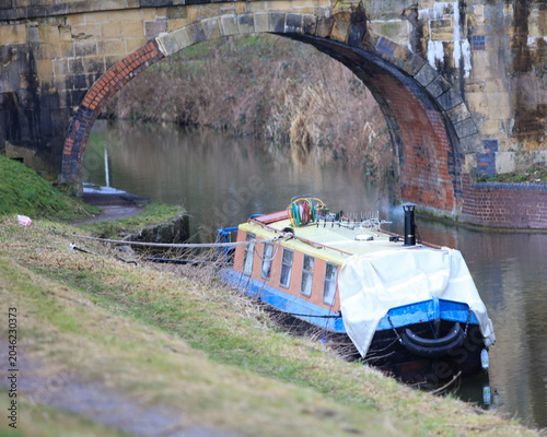 Narrowboat on an English canal. All tied down and prepared against the winter cold.