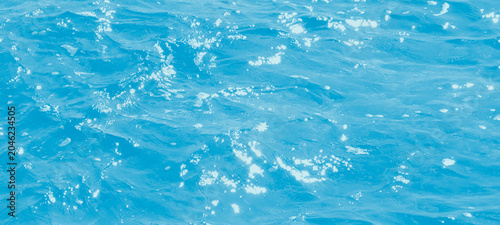 Canvas Print Bright blue sea surface with shimmering sun light reflections and soft water rip