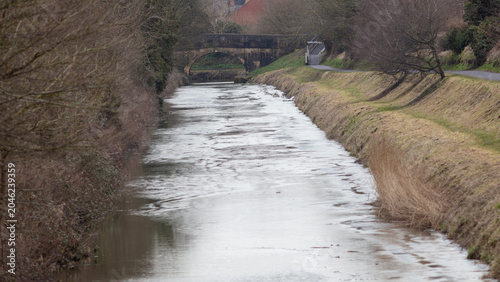 English canal in winter. Iced over with no boat traffic.