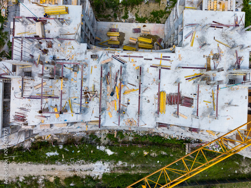 Фотография Construction site showing unfinished building with scaffolding and materials in