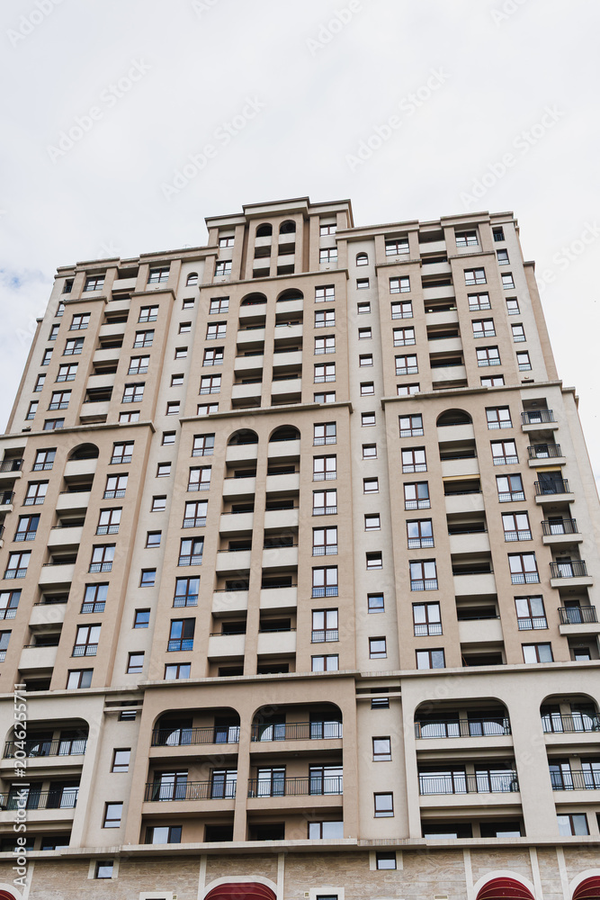 Fototapeta premium Charming facade with stylish features. Architectural elements highlight urban residential aesthetics. Sculpted archways and canopy details enhance city street appearance