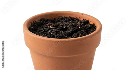 Terracotta pot filled with rich dark soil on white background