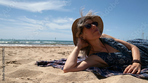 Senior Woman Relaxing on Sandy Beach 