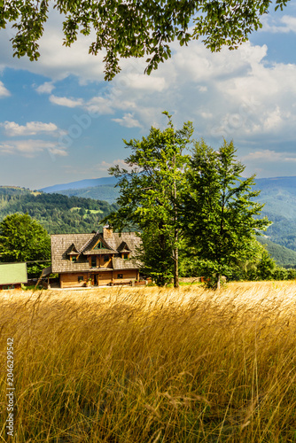 Summer in the Polish mountains. A traditional wooden highlander agritourism farm. Koszarawa, Beskid Mountains, Silesia, Poland