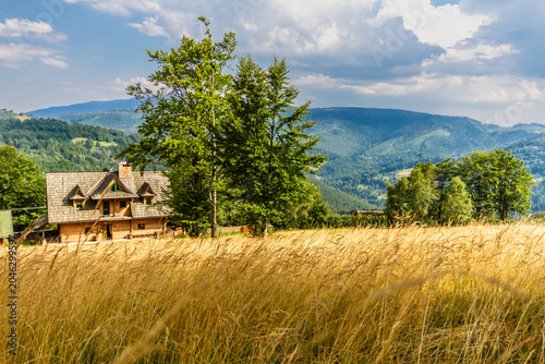 Summer in the Polish mountains. A traditional wooden highlander agritourism farm. Koszarawa, Beskid Mountains, Silesia, Poland