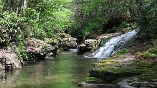 Water cascades down a picturesque waterfall where remote rivers join