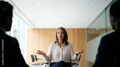 Professional mediator facilitating a discussion in a bright meeting room with copy space