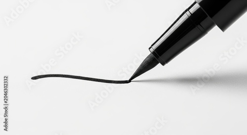 Liquid eyeliner pen tip drawing a precise black line on a clean white surface. Concept of makeup precision, beauty routine, and cosmetic application