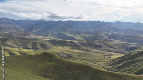 Wide Aerial Panorama Of Undulating Plateau And Distant Drakensberg Summits, Cinematic Sweep Captures Light