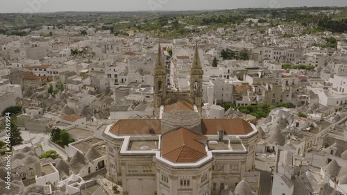 Aerial views of Alberobello’s iconic trulli rooftops, winding streets, and sunlit limestone houses, capturing the charm and symmetry of this UNESCO-listed Italian village.