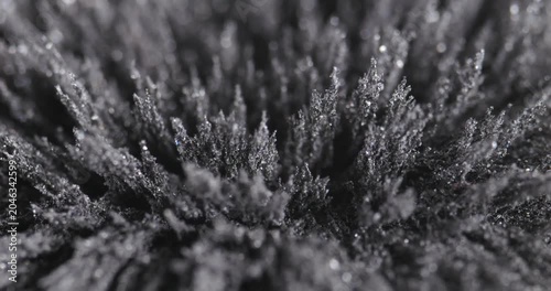 Metal dust, shavings, iron powder under the influence of a magnetic field. Abstract background.