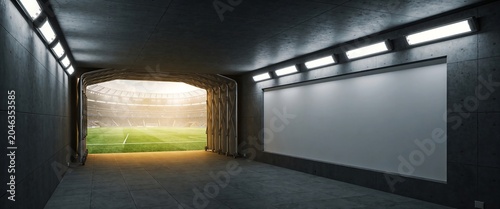 Modern sports stadium tunnel entrance with blank billboard and soccer field view