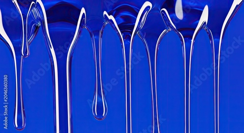 Vibrant blue liquid dripping, forming streaks and drops on a glossy reflective surface, abstract fluid texture background.