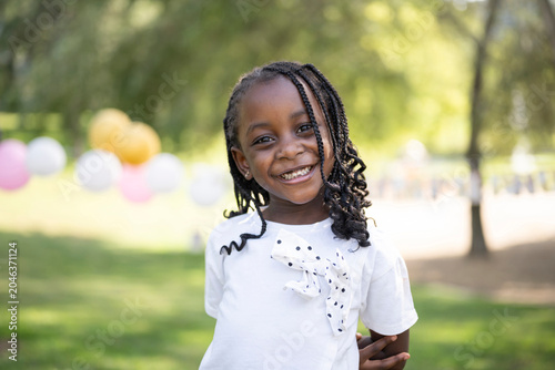African american girl smiling at park birthday party