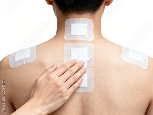 man with nicotine patches on back and shoulder for smoking cessation