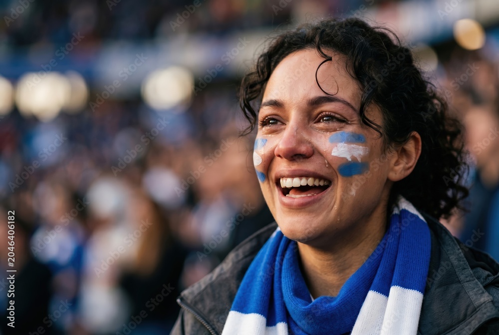 Naklejka premium Female sports fan celebrating with joyful tears at stadium