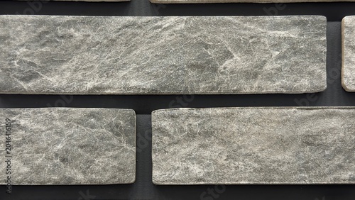 Tableau sur toile Dark grey stone brick wall texture background with rustic slate marble tiles