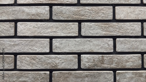 Fotografía Light grey loft brick wall texture background with rustic cement tiles