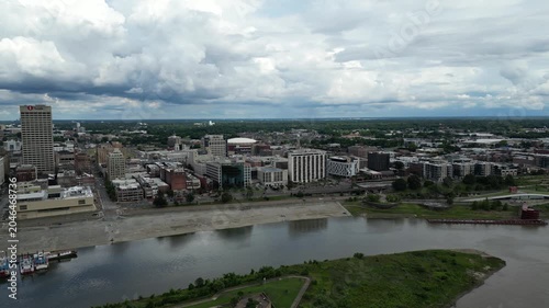 Aerial drone footage of a city skyline along a river