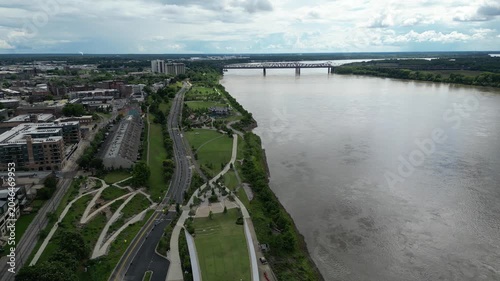 Aerial view of riverfront park and bridge in city