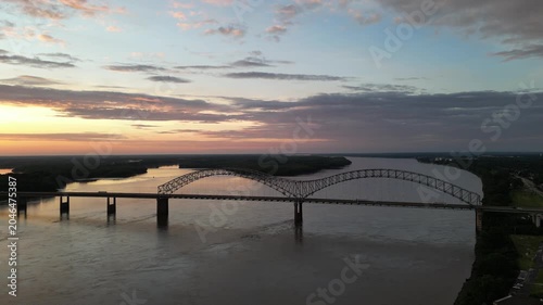 Aerial view of bridge over river at sunset
