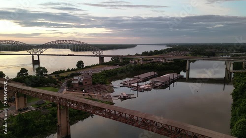 Aerial view of multiple bridges over a wide river at sunset