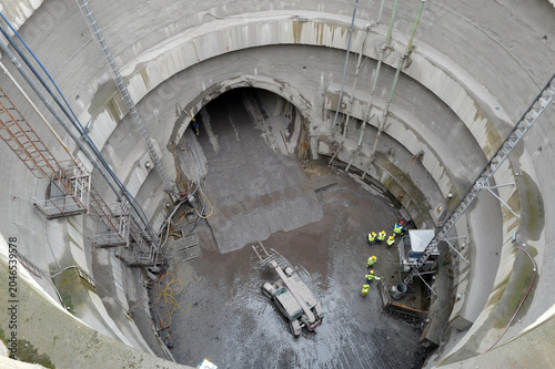 view of machines in the mining shaft of the tunnel construction under the city