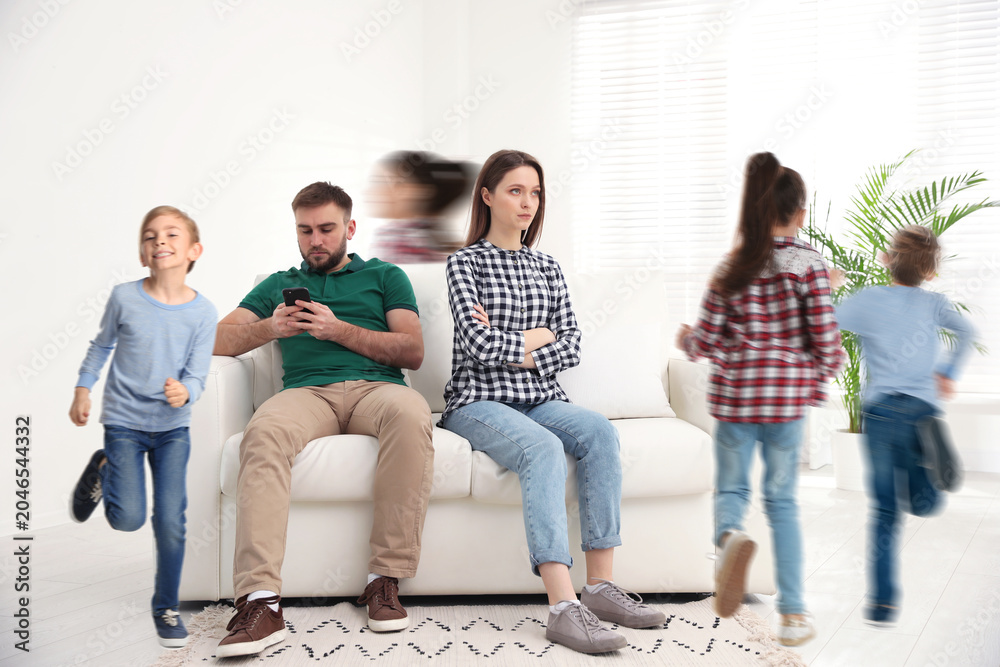 Fototapeta premium Family with hyperactive children. Daughter and son running around tired parents at home