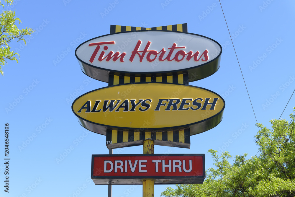 Obraz premium classic iconic road side pylon sign at Tim Hortons, a coffee shop chain, located here at 895 Jane St (at Dalrymple Dr), Toronto