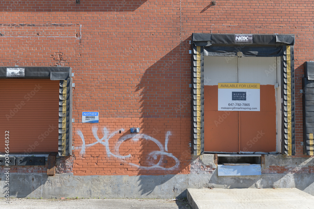 Obraz premium old dock portals with Real Estate sign at 2255 St Clair Av W, Toronto (formerly CMP Meats)