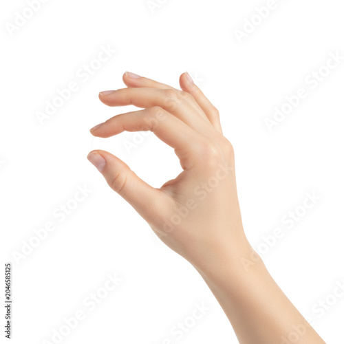 Fair female hand with slender manicured fingers pinching thumb and index finger in a studio against a transparent background precision and elegance concept