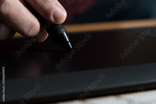 Fényképezés Hand Holding Graphic Pen Over Table