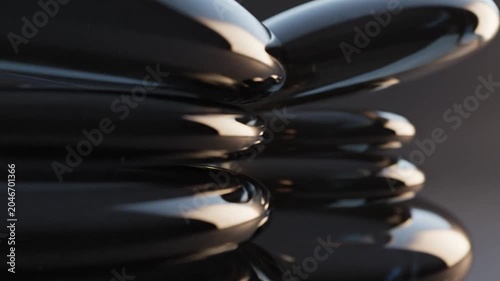 Balanced stack of polished dark stones with soft lighting
