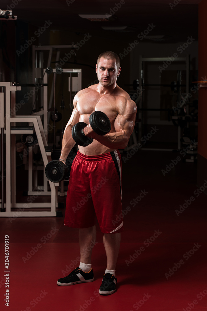 Fototapeta premium Healthy Young Man Doing Exercise For Biceps