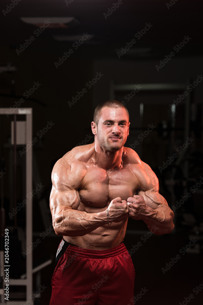 Fototapeta premium Muscular Man Flexing Muscles
