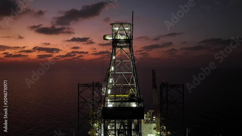 Aerial view of offshore jack up rig and offshore platform during sunset for oil and gas exploration and production. 