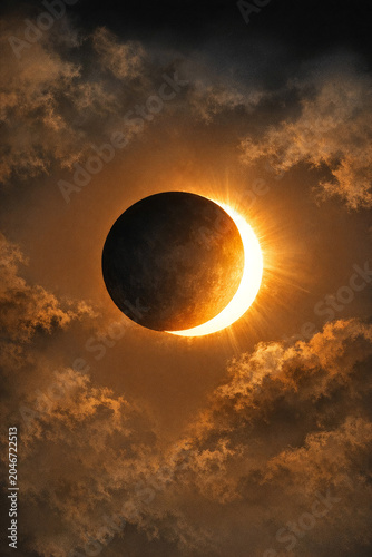 Golden sun partially hidden behind dark celestial body