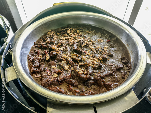 Fotografie Indonesian Beef Stew Semur Daging Served in a Metal Bowl with Sliced Onions and