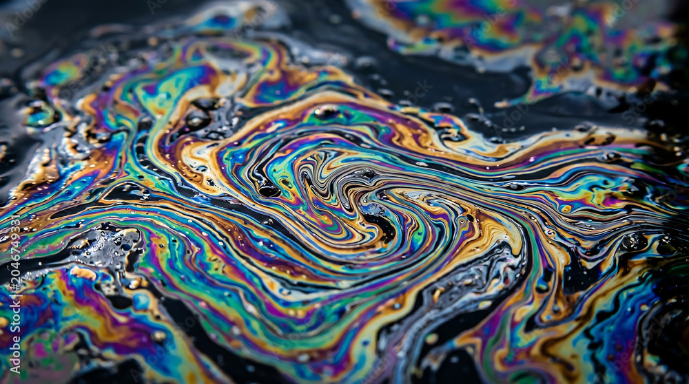 Obraz premium Swirling abstract oil paint texture with vibrant rainbow colors creating mesmerizing organic patterns under dramatic lighting