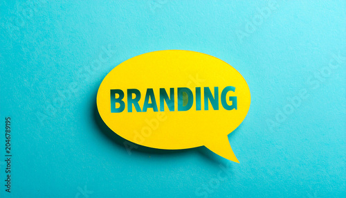 Branding Speech Bubble: A vibrant yellow speech bubble with the word BRANDING cut out of it, set against a striking teal background, symbolizing communication and identity in marketing.