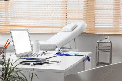 Doctor's desk with laptop a...