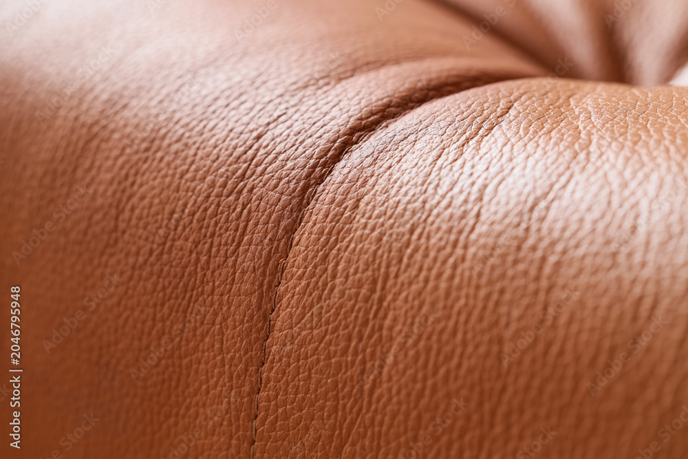 Fototapeta premium Texture of brown leather sofa, closeup